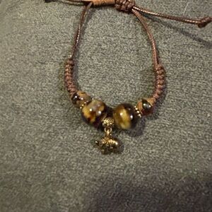Brown Beaded Bracelet with Gold Accents and an elephant charm